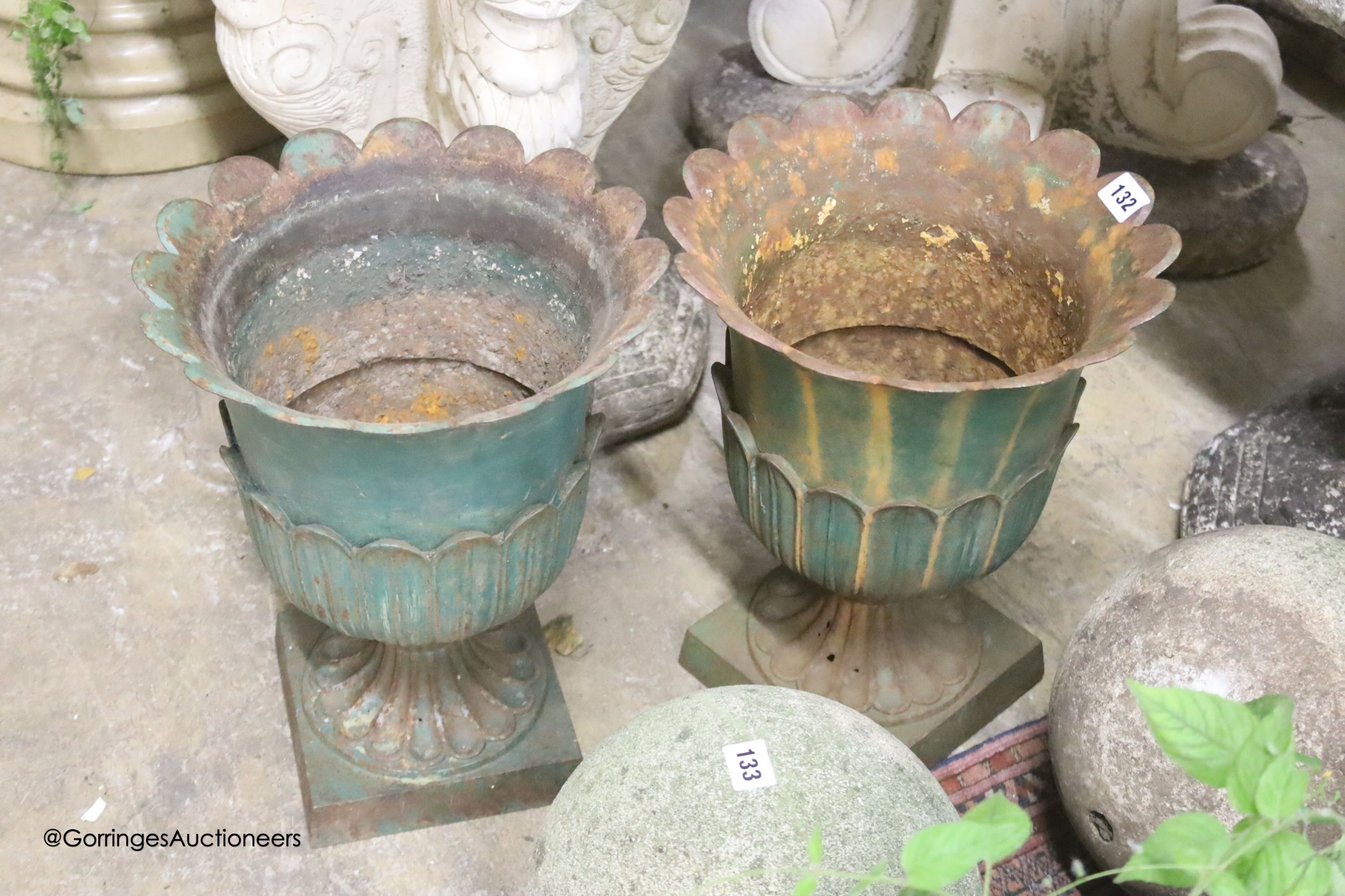 A pair of painted cast-iron garden urns